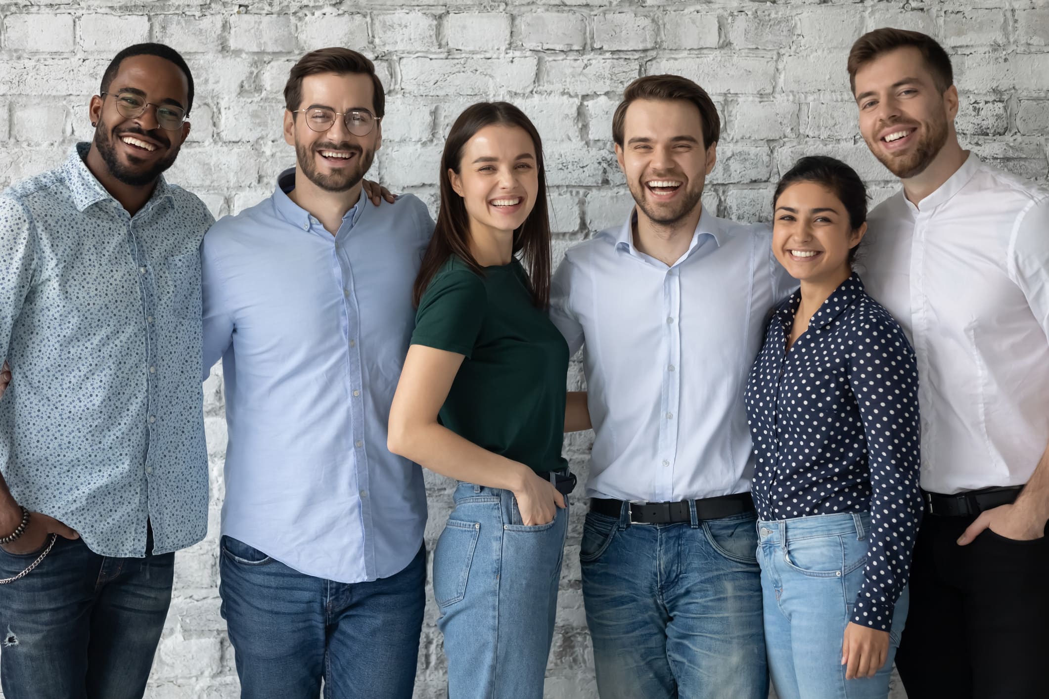An office team smiles for the camera during a photo session for their Maui business.